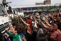 Uighur residents protest against paramilitary police on the ...