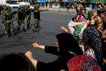 Uighur residents protest in Urumqi, China, Tuesday, July 7, ...